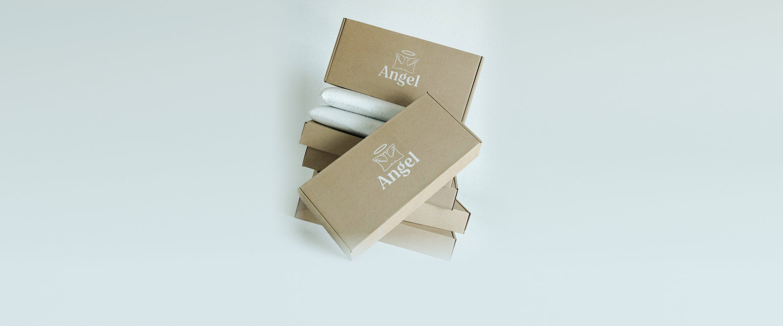 Angel Pillow kraft boxes stacked with two pillows